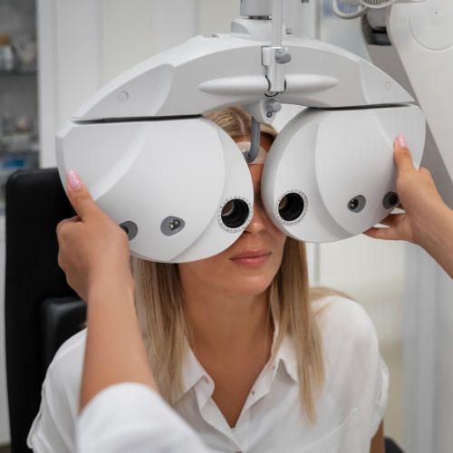 A patient having their vision checked with optometry equipment