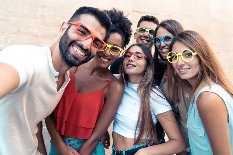 Friends wearing colourful glasses